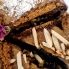 Sliced Persian Ranginak dessert filled with dates and walnuts
