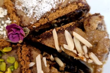 Sliced Persian Ranginak dessert filled with dates and walnuts