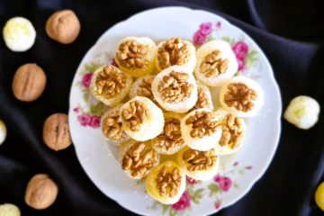 Homemade Persian baslogh coated in coconut flakes and topped with walnuts
