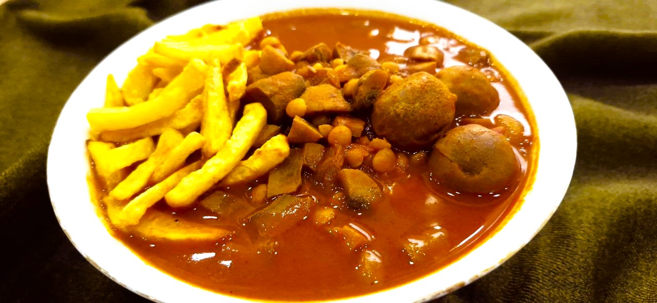 Vegan khoresh gheymeh with mushrooms, yellow split peas, and crispy potato fries
