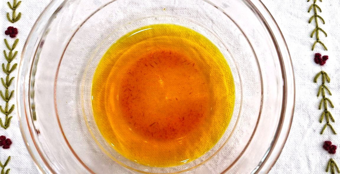 Brewed Persian saffron in a glass bowl with boiling water