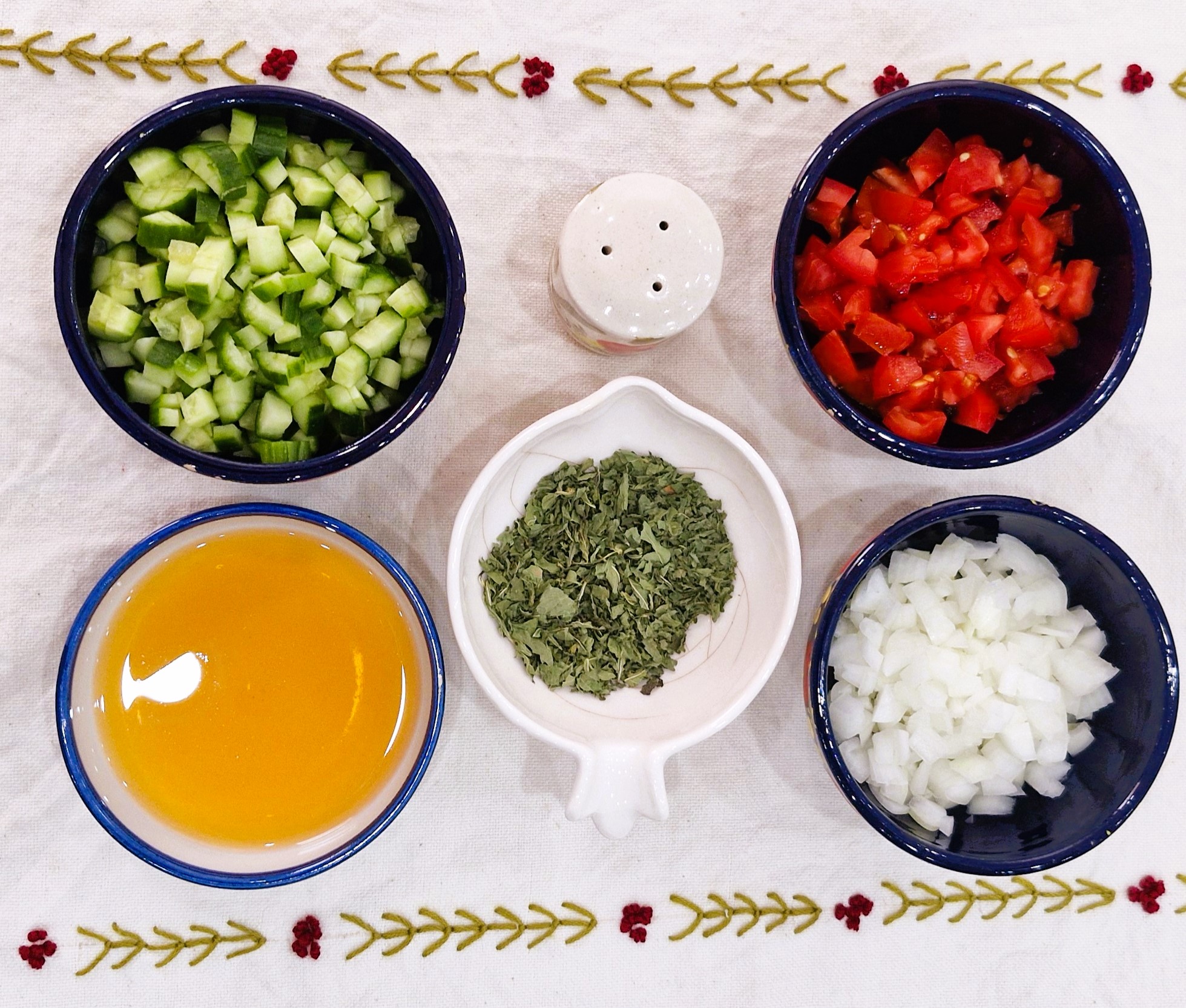 Shirazi Salad Ingredients and Dressing Shirazi Salad ingredients with chopped cucumber, tomatoes, onion, dried mint, salt, and verjuice